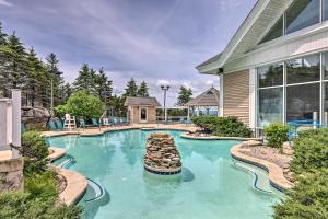 a swimming pool in front of a house at Snowshoe Condo with Mtn Views, Walk to Ski Lift in Snowshoe