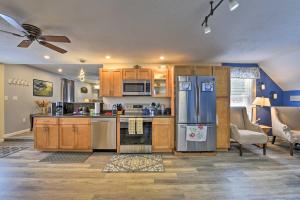 a kitchen with wooden cabinets and stainless steel appliances at Cozy Getaway - 10 Miles to Mount Wachusett Skiing! in Leominster