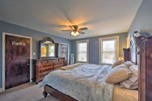 a bedroom with a bed and a dresser and a ceiling fan at Cozy Getaway - 10 Miles to Mount Wachusett Skiing! in Leominster