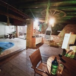 a room with a table and a swimming pool at Pousada Flores em Vida in Olímpia