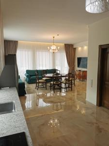 a dining room and living room with a table and chairs at Beach Lounge Luxory Apartments in Klaipėda
