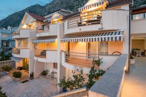 a building with balconies on the side of it at Apartments Ivardić in Kotor