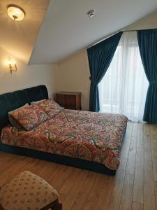 a bedroom with a bed and a large window at Beach Lounge Luxory Apartments in Klaipėda