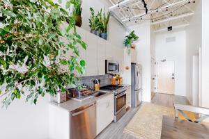 a kitchen with white walls and potted plants at Aspen Crossing in Bozeman