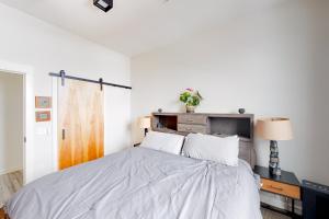 a white bedroom with a bed and a desk at Aspen Crossing in Bozeman