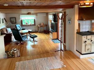 a living room with a couch and a table and a television at 8 person holiday home in ULRIKA-By Traum in Rimforsa