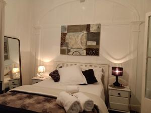 a bedroom with a bed with towels on it at Classic Queenslander Suite in Townsville