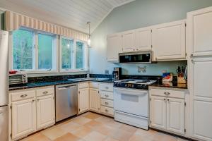 a kitchen with white cabinets and a stove top oven at Seabrook Sanctuary - 1706 Courtside in Seabrook Island