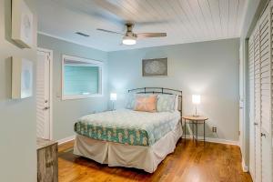 a bedroom with a bed and a ceiling fan at Seabrook Sanctuary - 1706 Courtside in Seabrook Island