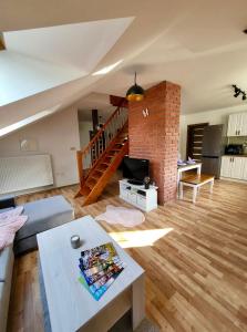 a living room with a staircase and a brick wall at HARMONY Apartments in Rajecké Teplice