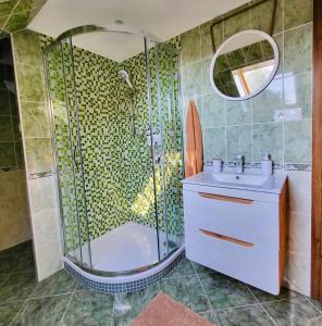 a bathroom with a shower and a sink and a tub at HARMONY Apartments in Rajecké Teplice
