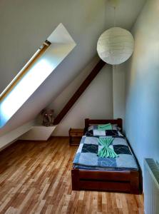 a bedroom with a bed in a attic at HARMONY Apartments in Rajecké Teplice