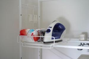 a iron is sitting on a shelf in a kitchen at Glass Shiseikan in Sapporo +188 photos