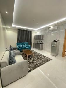 a living room with a couch and a table at غيوم الريف للشقق المخدومة - إقتصادي - Ghyoum Alrif For Serviced Apartments - Economy in Abha +8 photos