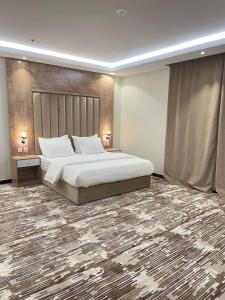 a bedroom with a large bed and a large carpet at فندق اريف in Abha