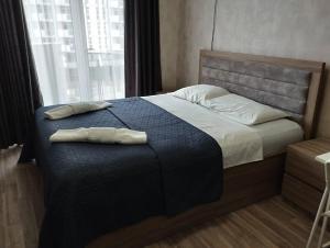 a bedroom with a bed with two towels on it at Apartment in Orbi Sea Tower in Batumi +18 photos