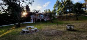 賈爾迪諾別墅的住宿－El Descanso，前面有一张野餐桌的房子