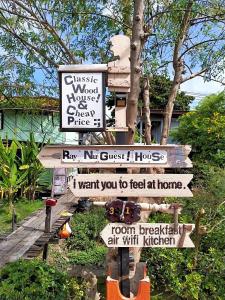 a street sign with many different signs on it at Ray Nu Guest House in Phra Nakhon Si Ayutthaya