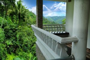 a balcony with a view of the mountains at Spring and Valley View in Thekkady