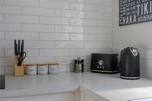 a counter with a toaster and a coffee maker on it at City Centre Escape in Napier