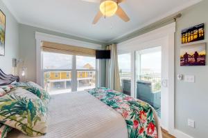 a bedroom with a bed and a large window at Cornerstone Beachside Cottage in Mexico Beach