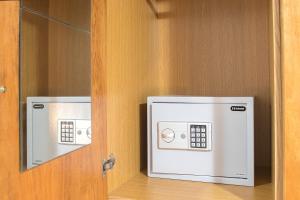 two microwaves are on a door in a room at D & E APARTMENTS in Skiathos Town