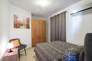 a bedroom with a bed and a desk and a chair at D & E APARTMENTS in Skiathos Town
