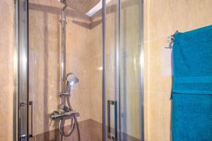 a shower in a bathroom with a blue towel at D & E APARTMENTS in Skiathos Town +23 photos