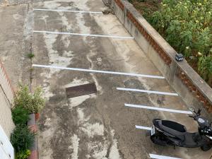an empty parking lot with a scooter parked in it at Three-night homes in Jincheng