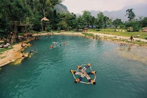 a group of people in the water at a beach at SD View Hotel in Vang Vieng