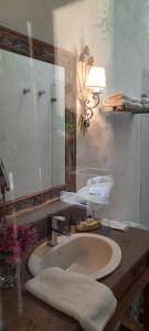 a bathroom with a sink and a mirror at Candelaria House Boutique in Bogotá