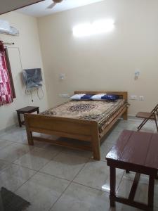 a bedroom with a bed in the corner of a room at Suloram illam in Chidambaram