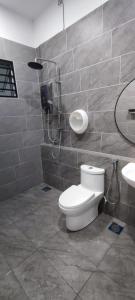 a bathroom with a toilet and a sink at FAMILY HOLIDAY HOME in Ipoh