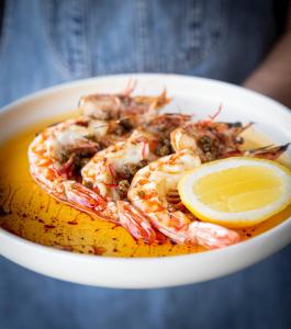 a white bowl of shrimp with a lemon slice at Samphire Rottnest in Rottnest Island