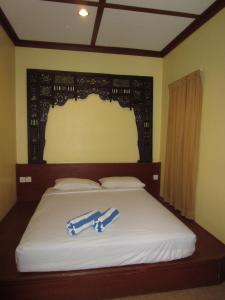 Ein Bett oder Betten in einem Zimmer der Unterkunft Sunset Beach Resort