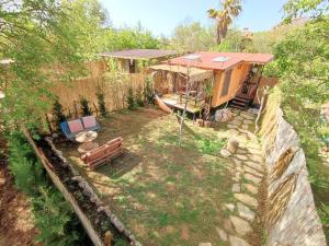 an aerial view of a house with a boat in a yard at Tiny House Ceviz Kayaköy Jungle Camping in Fethiye