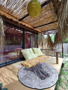 a patio with a bed and a table on a deck at Tiny House Ceviz Kayaköy Jungle Camping in Fethiye