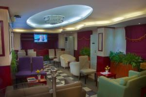 a lobby with couches and chairs and a chandelier at Al Farhan Apartment Al Hamra-Jeddah in Jeddah