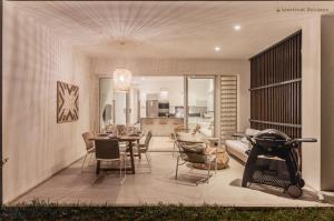 a living room and dining room with a table and chairs at O'Biches Beachfront Complex - Trou aux Biches in Trou aux Biches