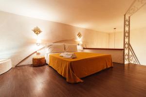a bedroom with a bed with an orange blanket at Finisterre Casa di mare - Housea in Polignano a Mare