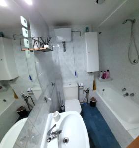 a bathroom with a sink and a tub and a toilet at Donostia Vintage House in San Sebastián