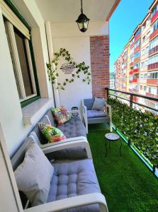 a balcony with two couches and a window at Donostia Vintage House in San Sebastián