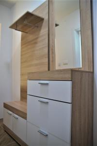 a white dresser in a room with a mirror at Central Modern Apt with Garden in Struga