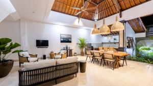 ein offenes Wohnzimmer mit einem Tisch und Stühlen in der Unterkunft Villa Casa Orana in Seminyak