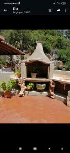 a picture of a bench in a garden at Elia's House in Padru