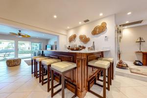 a kitchen with a bar with stools at Tropical Paradise in Fort Lauderdale