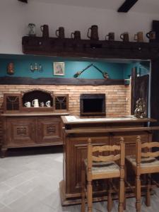 a kitchen with a fireplace and a table and chairs at Dom gościnny Krystyna in Władysławowo