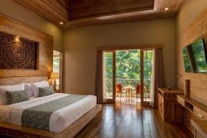 Postel nebo postele na pokoji v ubytování Arkamara Dijiwa Ubud