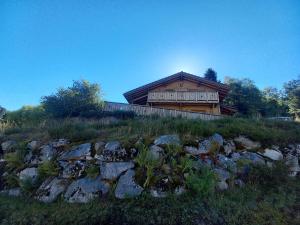 a house on top of a hill with rocks at Chalet Typique Vosgien "les Barbotines" in Ventron