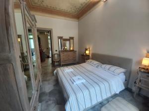a bedroom with a bed with a mirror and a dresser at Borromini Home in Turin